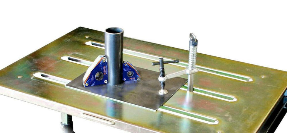 Metal welding table with tube, corner magnets, and welding clamp setup