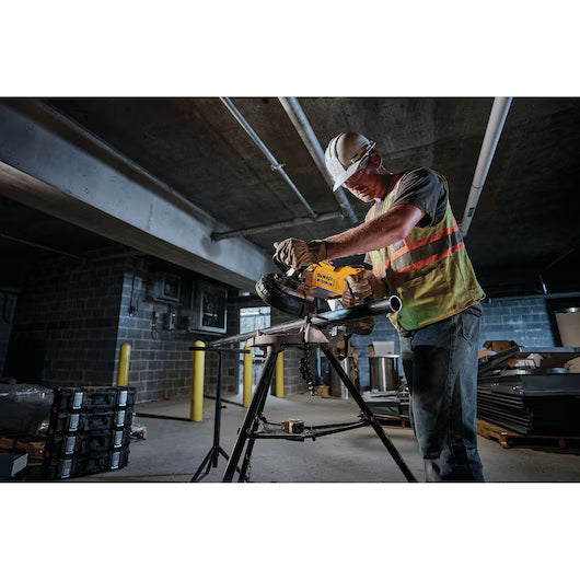 Construction worker using DEWALT cordless bandsaw to cut metal pipe indoors