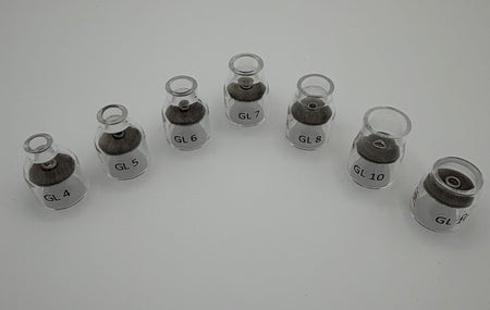 Set of clear glass TIG welding cups labeled GL4 to GL10 arranged in a curved row on white