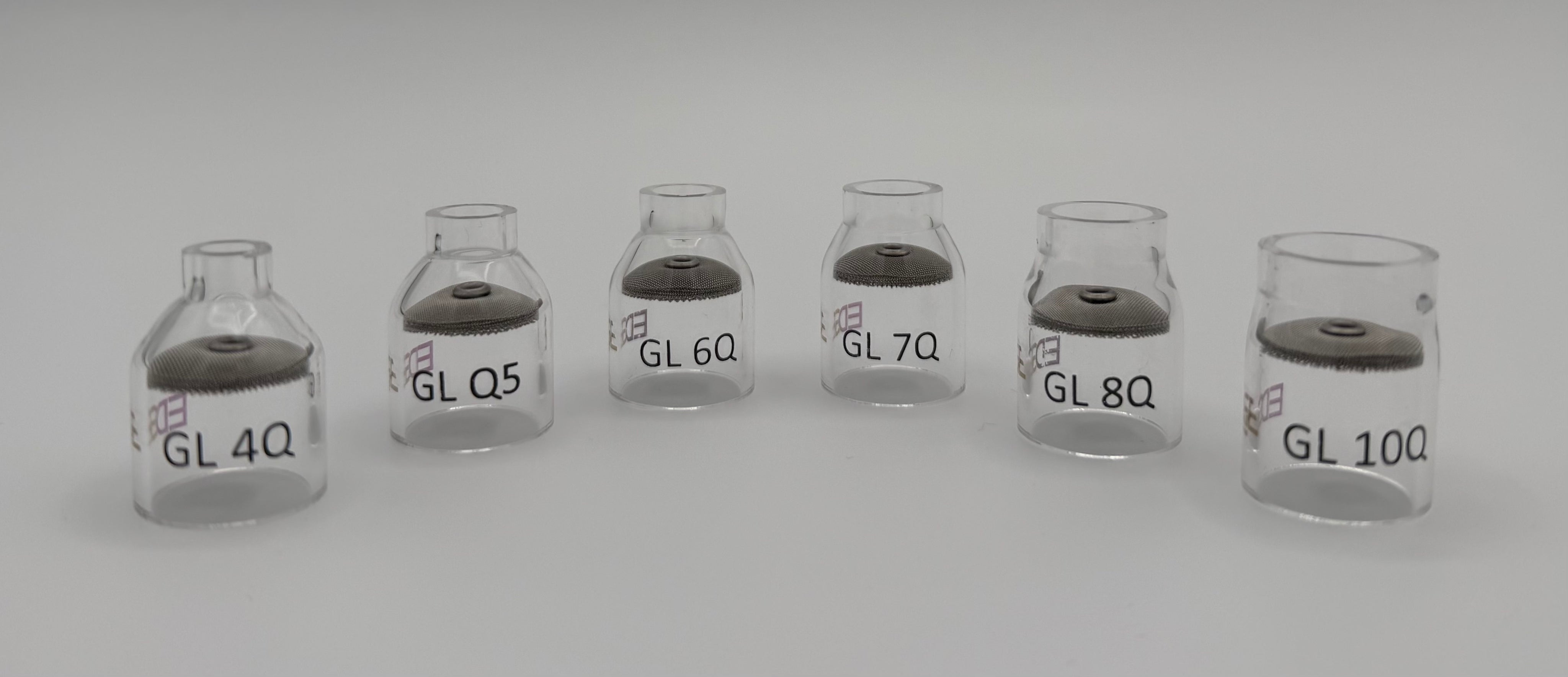 Clear glass welding gas lens cups in various sizes on a white background