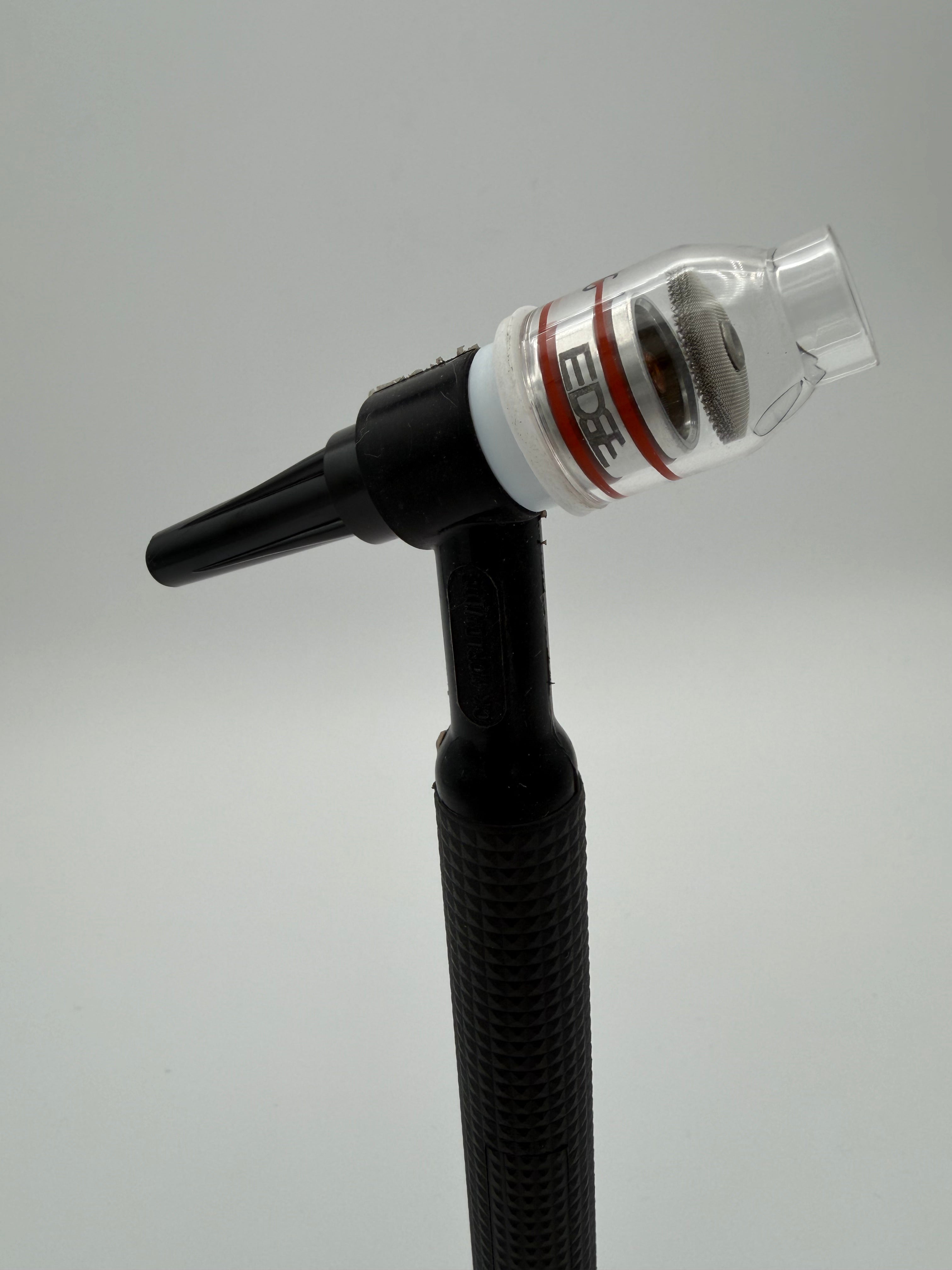 EDGE clear welding cup attached to black TIG welding torch against grey background