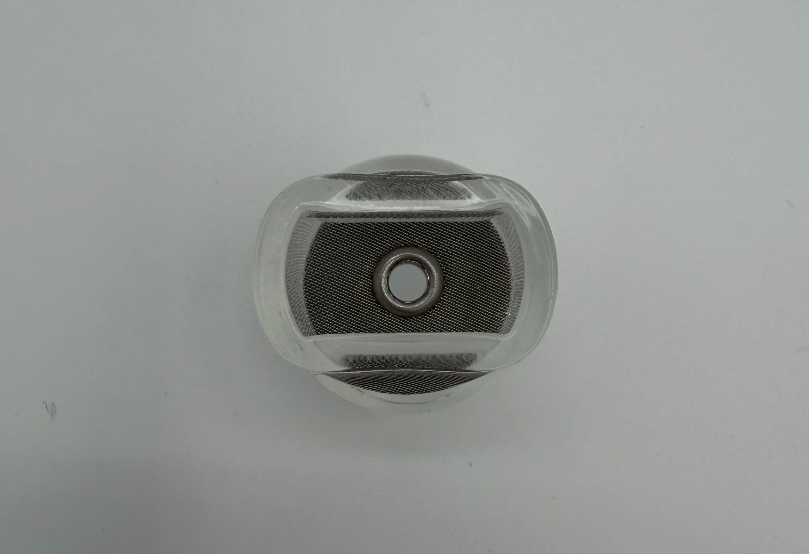 Clear welding cup with fine mesh screen, viewed from above on a white background