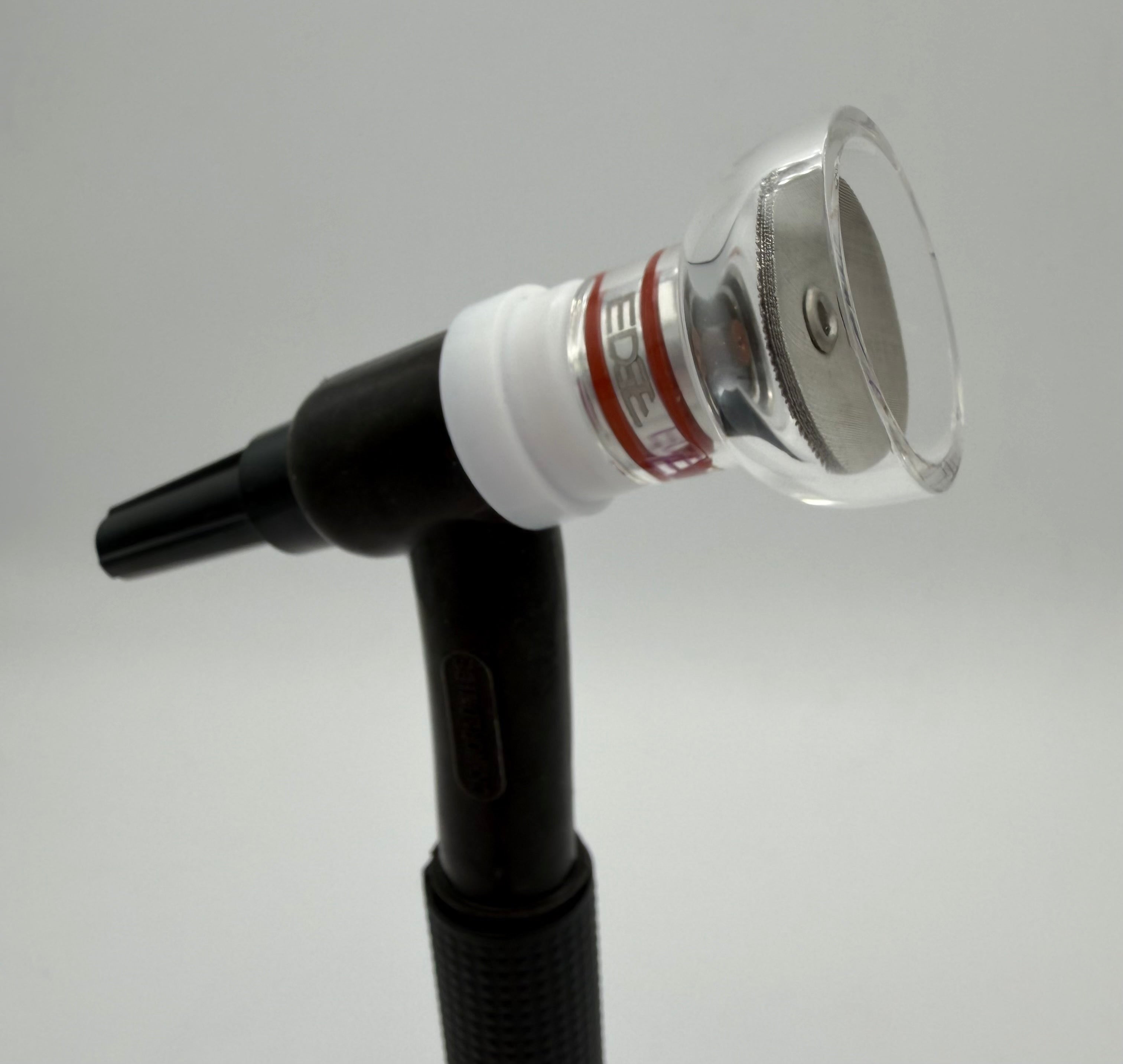 Clear welding cup on TIG torch, transparent edge and metal mesh, white background