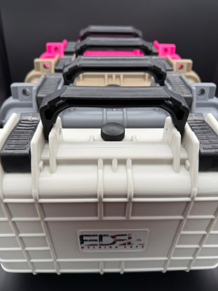 Stacked hard plastic tool cases with black handles in multiple colors, viewed close-up