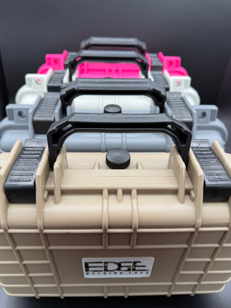 Stack of durable plastic welding equipment storage cases in tan, gray, white, and pink