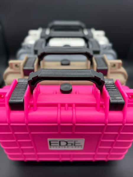 Stacked durable protective carrying cases in pink, tan, gray, and white on black background
