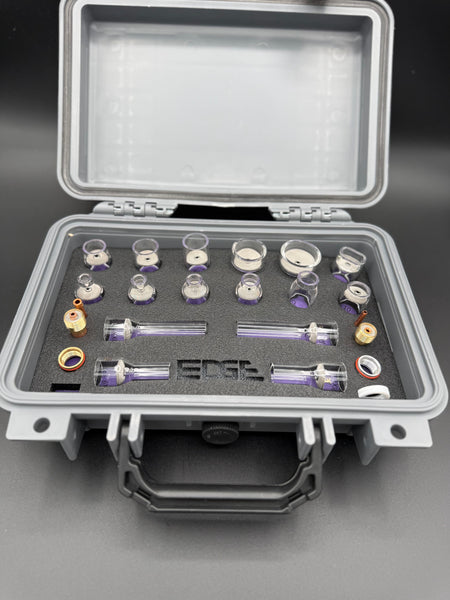 Welding cup kit with glass cups and metal fittings arranged in a foam case