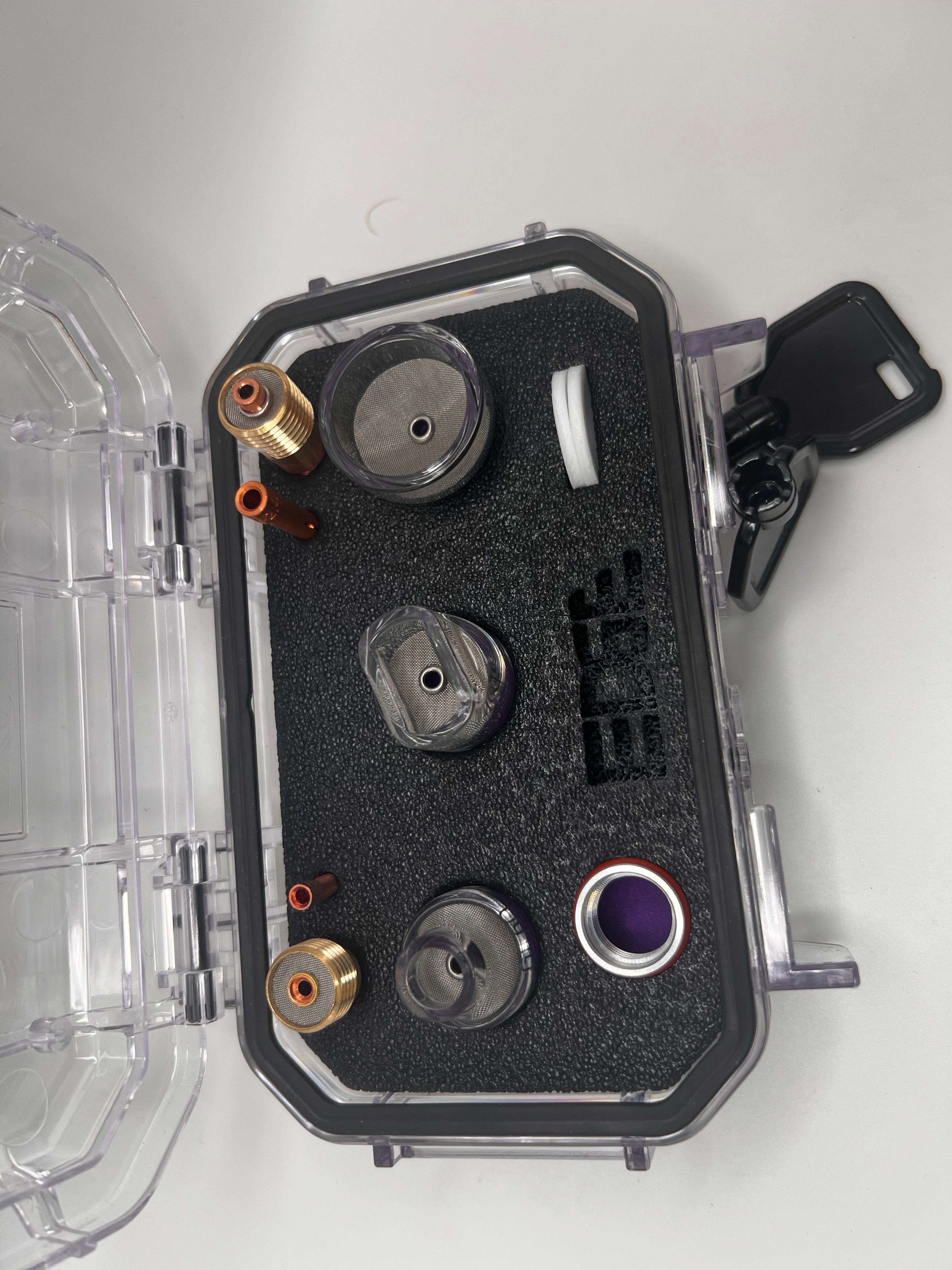 Protective case with metal vape accessories and mesh screens on foam insert