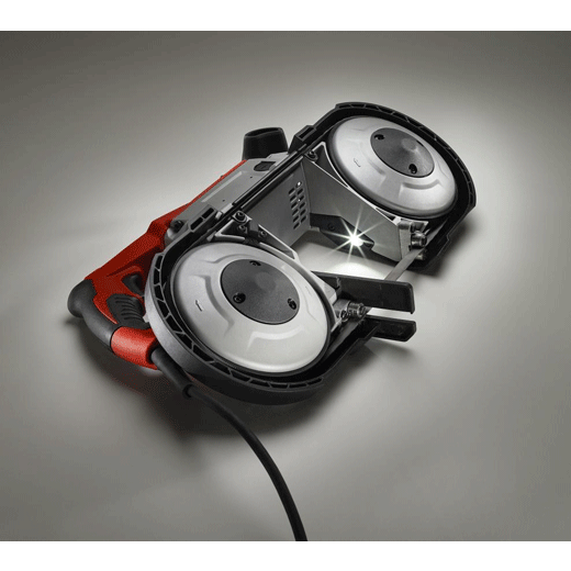 Electric portable band saw with red handle and LED work light on a grey background