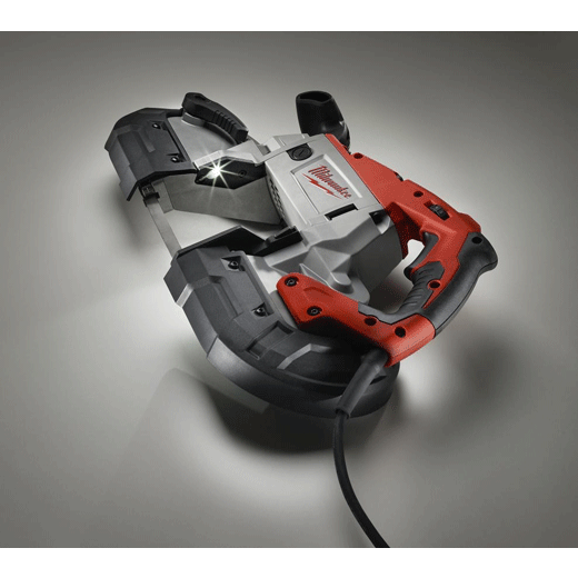 Milwaukee portable band saw with red and black handle, powered on, studio lighting